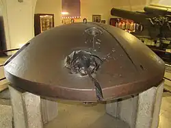 A turret cupola from one of Antwerp's fortresses hit and split by a 30.5 cm shell during the Siege of Antwerp in 1914.