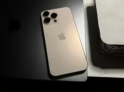 The rear of an iPhone 16 Pro Max in Desert Titanium