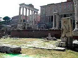 Ancient Roman ruins: the tall columns of the Temple of Saturn are visible in the background