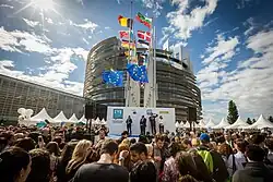 European Parliament opening in Strasbourg with crowd and many countries' flags on flagpoles