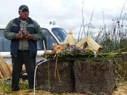 A Uro man showcasing his artisan work to tourists.