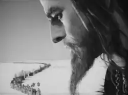 Ivan's head, disproportionately large, towers over the lines of common people in the background.