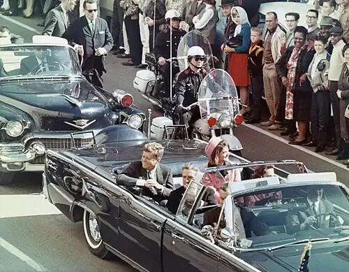 President John F. Kennedy, his wife Jacqueline, Texas governor John Connally, and Connally's wife Nellie in the presidential limousine minutes before the assassination in Dallas