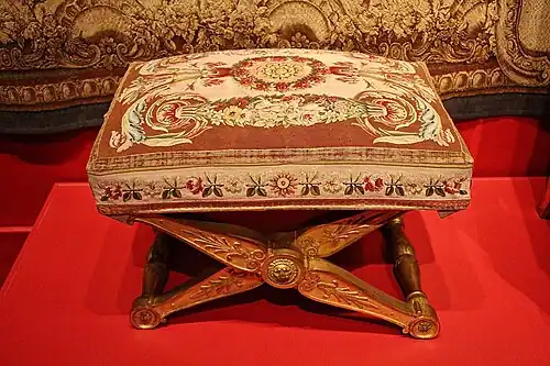 Neoclassical palmettes on a stool, by François-Honoré-Georges Jacob-Desmalter, 1804, carved and gilded wood, and Beauvais tapestry, in a temporary exhibition called Art and Court Life in the Imperial Palace at the Montreal Museum of Fine Arts, Canada