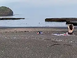 A black sand beach in south-western Jeju