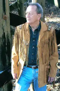 Jim Barnes standing and gazing off in the distance