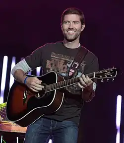 Josh Turner strumming an acoustic guitar