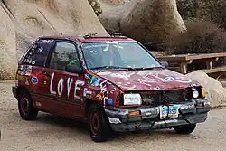 Ford Festiva Jalopy car in Joshua Tree National Park in Hidden Valley Campground. A "derby car" is a typical term for a decrepit car used for racing, often spray painted or decorated in various ways.