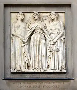 Justice is redundant as all crime is conquered; Virtue on the left passes to Justice the palm of victory and takes the sword. Justice passes the scales of justice to Concord.