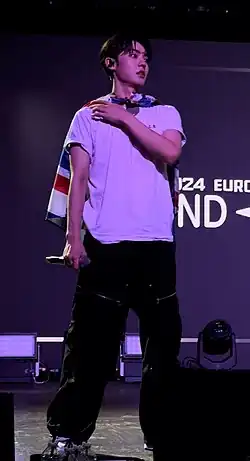 Kang Yuchan standing on stage