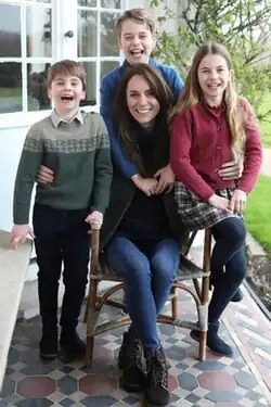 The Kategate photograph, showing Catherine sitting on a chair surrounded by her three children.