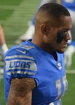 Kenny Golladay in a Detroit Lions uniform from the side. Shown with no helmet and with face paint.