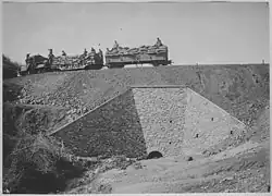 Military logistics train on a high embankment
