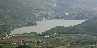 A body of water surrounded by greenery.