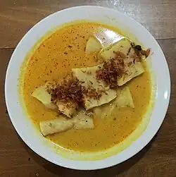 Laksan Palembang, fish cake similar to pempek served in rich coconut milk-based soup, and sprinkled with crispy fried shallot