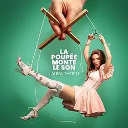 Revamped cover for the single featuring the singer Laure Thorn as a marionette doll and being controlled by strings held by a large hand. The title and author names are in the centre of the cover.