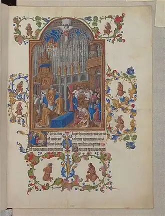 Duke of Berry Christmas Mass. An illuminated manuscript featuring an image of a cathedral, mainly brown, blue and white with some red highlights. Priests and assistants are saying Mass at the left at the high altar. Choristers are singing in the mid-right background. Two literate aristocratic ladies are settled in front attending to their prayer-books. Other lay participants are watching from standing and kneeling positions at far right.