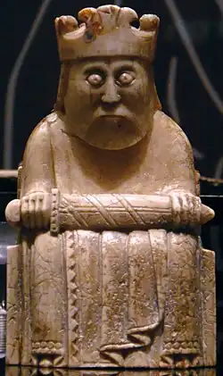 Photograph of an ivory gaming piece depicting a seated king