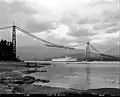 Lions Gate Bridge under construction with Empress of Japan II passing underneath. 1938.