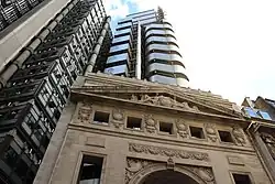 The Lloyd's building (1986) in the City of London, overshadowing the preserved facade of its predecessor (1928).