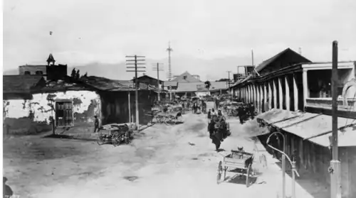 1882 view, looking north from Broad Place along Calle de los Negros to the Ignacio Del Valle adobe in the far background. At left, with the peeling paint, is the Coronel Adobe (SE corner of Arcadia). A few years later, both adobes would be demolished and Los Angeles St. would be extended northward to (and past) the Plaza.