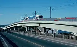 A MAX train traveling across a long viaduct