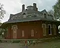 Brick house with, unusually, the timber frame second floor built into the roof structure. Gregg-Crites Octagon House in Circleville, Ohio (built 1855–56).