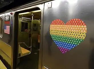 An MTA Pride logo on the side of a New York City subway train.