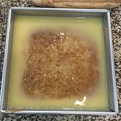 Sauce poured over pudding to soak in