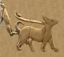 Naked man with penile sheath (fragment) walking a dog on a leash (Back, 5th register).[38][37] Naked and shaven-headed men are a regular fixture of the Art of Uruk and Sumerian religion.[38]