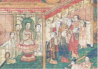 Seven lay believers worship in front of the Mani statue in the shrine