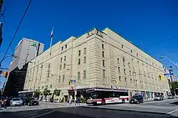 An exterior view of a building. The building has a sign that says "Maple Leaf Gardens" on the front.