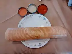 Masala dosa served traditionally with chutney, sambar, sauteed potato filling
