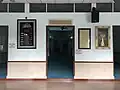The entrance to main prayer hall with digital clock for prayer times on the left side.
