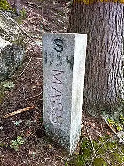 MassachusettsConnecticutstatelinemarkerdated1954atnorthernendofBreakneckPondfacingsouth