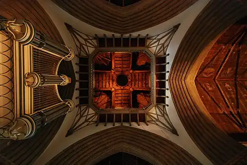 The interior of the chapel from under the tower, looking towards the roof, with the former organ on the left