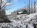 A train formation crosses the snowy landscape between Gonnet and City Bell