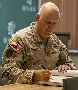 2024 color photo of Major general Michael Wegscheider in camouflage uniform, seated at desk during visit to Lithuania