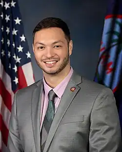 San Nicolas smiling in a suit