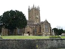 Elaborately ornamented stone building with square tower.