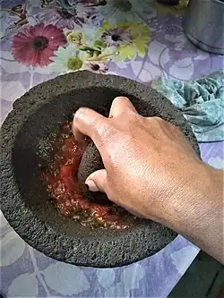Grinding in a molcajete, San Juan Achiutla, Oaxaca, México