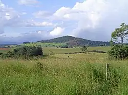 Mt Quincan, viewed from the south, showing the southern quarry with the main scoria cone behind it to the west and the low-lying crater to the east.
