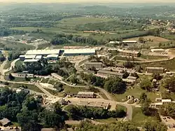 An aerial photograph of a series of two- and three-story buildings on a hill