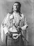 A nineteenth century photograph of a Plains Indian showing a belted bag known as a medicine pouch