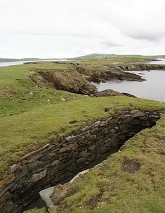 Northern part of the Ness looking inland towards Scatness. The structure in the foreground is part of the Ness of Burgi fort