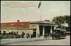 A postcard of a railway station with an Egyptian Revival style facade