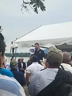 Pat Ryan speaking to the crowd through a bullhorn