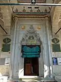 Entrance portal to the prayer hall, with muqarnas hood and calligraphic inscriptions