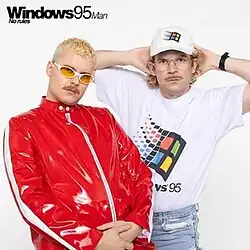 The cover artwork for "No Rules!". The cover features Keisteri as his stage persona, Windows95man, along with singer Henri Piispanen dressed in a red jacket amongst a grey background.