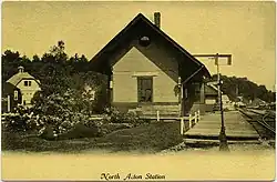 A postcard photo of a small railroad station